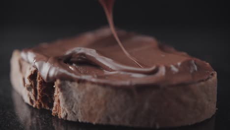 Spreading-chocolate-cream-on-a-slice-of-rye-bread