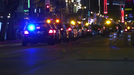 Lot-of-Police-cars-parked-on-the-illuminated-streets-of-Los-Angeles,-USA---static-view
