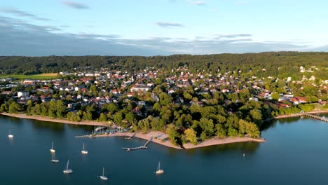 Aerial-view-flying-drone-of-town-Herrsching-at-Ammersee-lake,-luxurious-residential-area-with-high-class-marina-and-beautiful-view