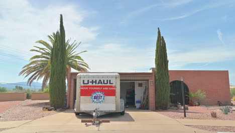 U-Haul-trailer-parked-in-front-of-a-home-with-open-garage