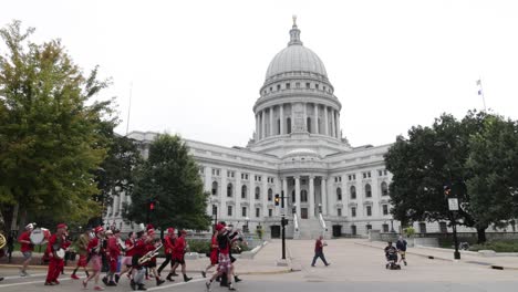 Wisconsin-state-capitol-building-with-marching-band-walking-by-in-stable-video