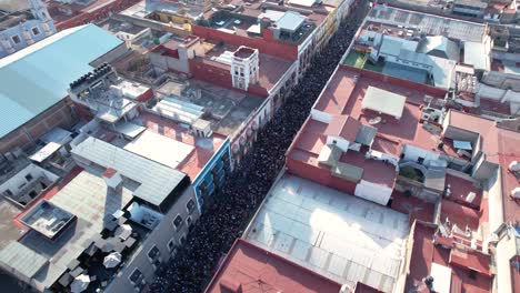 Aerial-footage-of-the-international-women´s-day-march,-the-crowd-in-the-streets-of-Puebla-city-historic-center