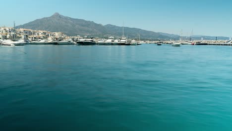 Luxury-yachts-in-harbor-of-Puerto-Banus,-Spain,-low-angle-time-lapse