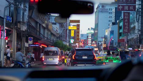 Car-view-of-Yaowarat-Road-in-Chinatown,-a-popular-travel-destination-in-Bangkok,-Thailand