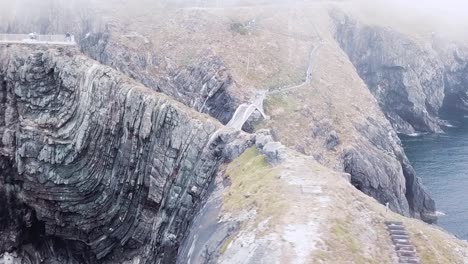 Mizen-Head,-Ireland,-dramatic-drone-shots-of-the-cliffs-on-a-misty-day