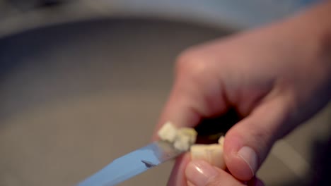 Chopping-Cutting-Garlic-On-The-Hands-With-A-Knife