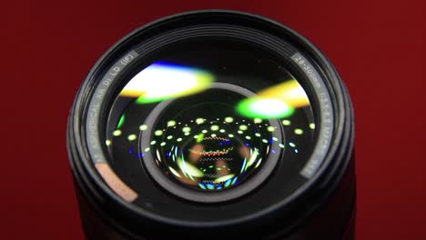 Close-Up-of-DSLR-Camera-Lens-In-Red-Background