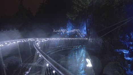 Circular-elevated-Platform-in-canyon-decorated-with-blue-Christmas-lights,-Rainy-night