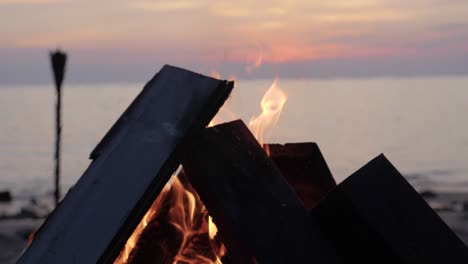 Bonfire-by-the-beach-at-sunset-in-Asia---ultra-slow-motion