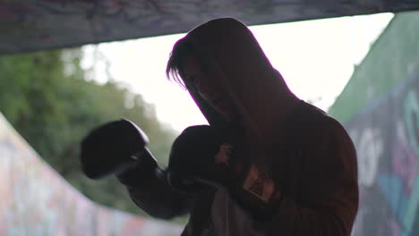 Medium-Shot-of-Young-Attractive-Man-Boxing-In-Underpass,-In-Slow-Motion
