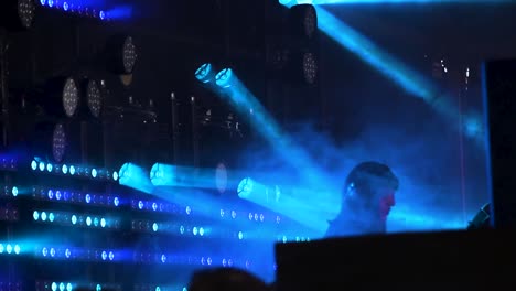 DJ-performing-with-lights-in-background