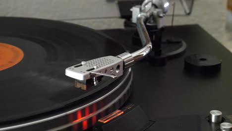 A-record-player-spinning-as-the-needle-drops-slowly-onto-the-vinyl-and-the-music-starts