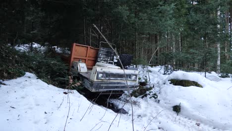Forest-machine-stuck-inside-the-snow,-A-young-man-is-walking-in-the-background