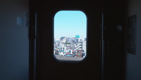 Looking-on-the-passin-g-town-through-the-train-window