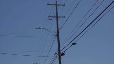 Driving-by-city-Power-lines-with-blue-skies-in-background