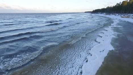 Seaside-icy-waves-in-winter-morning-light