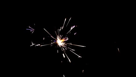 Sparkler-fireworks-with-shower-of-sparks-flying-against-a-black-background