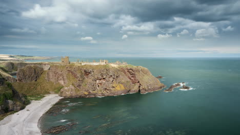 A-timelapse-of-Dunnottar-castle-on-a-sunny-day-with-clouds-moving-overhead-and-receding-into-the-distance,-Stonehaven,-Aberdeenshire
