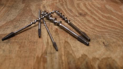 Old-drillbits-on-wooden-table-in-woodshop
