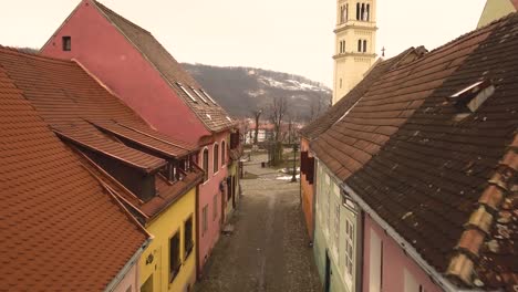 A-beautiful-landscape-with-a-car-passing-by-stone-street-and-a-church-on-background-in-the-famous-Sighisoara-medieval-town