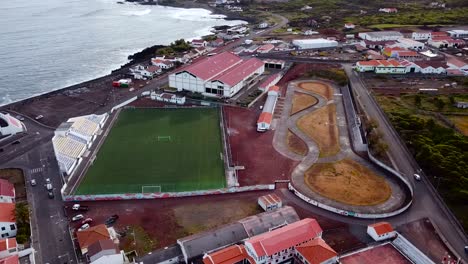 Aerial-Footage-of-a-Football-ground-and-Race-track-at-Madalena-town-in-Pico-Island,-Azores