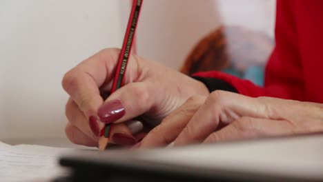 Woman-writing-with-pencil-in-a-book