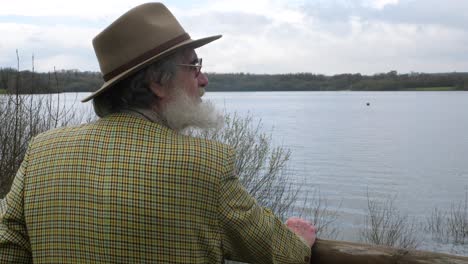 An-old-man-looking-out-over-the-lake-thinking-about-history
