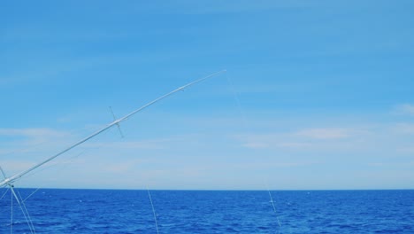 Fishing-outrigger-deep-sea-trolling,-Curacao,-Caribbean,-with-blue-sky-and-ocean