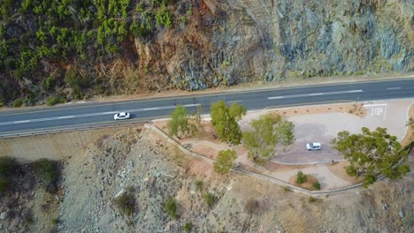 Car-parked-on-the-side-of-a-winding-road-in-South-African-mountains-aerial
