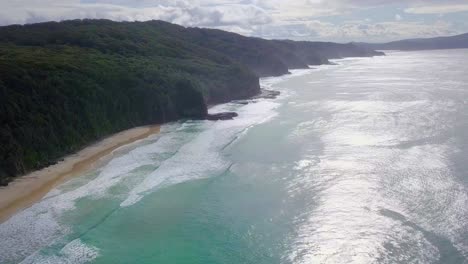 Spectacular-aerial-morning-flight-over-wild-colorful-ocean-and-cliffs,-Australia