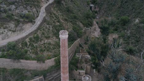 Aerial-shot-of-the-chimney-in-the-Masonica-Spanish-Mine-appearing-from-the-back-in-Real-de-Catorce,-San-Luis-Potosí,-Mexico