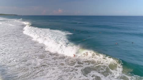 Aerial-shot-of-two-surfers-surfing-a-tube-barrel-wave-in-Zicatela-beach-Puerto-Escondido,-Oaxaca