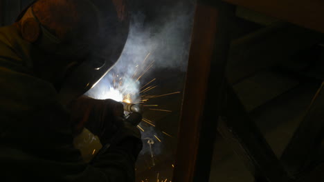 Sparks-fly-as-a-factory-worker-welds-steel-framing-in-an-industrial-machine-shop