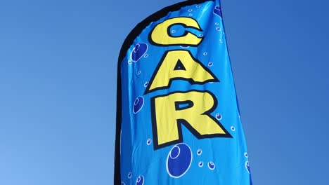 Generic-Car-Wash-sign-flag-waving-in-the-wind-on-a-very-blue-day