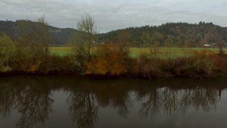 Drone-aerial-of-the-Coquille-River-Valley-in-Southern-Oregon-Pacific-Northwest-and-reflections-of-trees-in-the-water