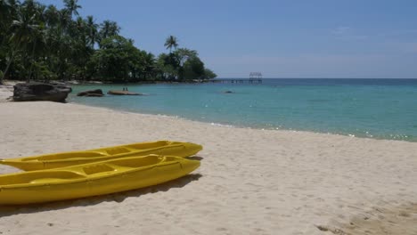 Two-yellow-kayaks-on-a-tropical-beach-on-an-beautiful-island