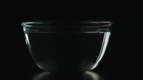 Slow-Motion-of-Chili-Dropping-in-Bowl-of-Water