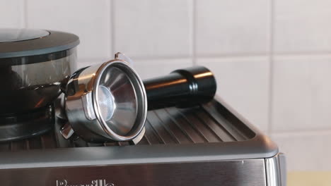 Hand-picking-up-Italian-Espresso-Cup-from-Espresso-Machine