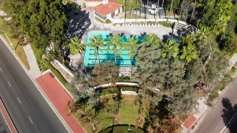 Aerial-fly-over-and-rotation-shot-over-a-community-park-and-pool
