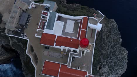 Aerial-light-house-in-Sagres-Portugal-revealing-coastline-cliffs