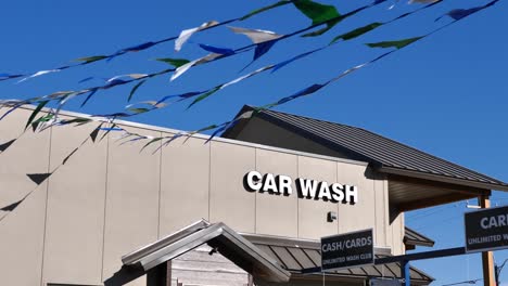 Generic-Car-Wash-building-with-blue-and-white-flags-waving-in-the-breeze