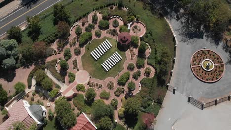A-drone-shot-closing-in-on-a-garden,-reception-venue-in-Cherry-Valley,-California-in-Riverside-County