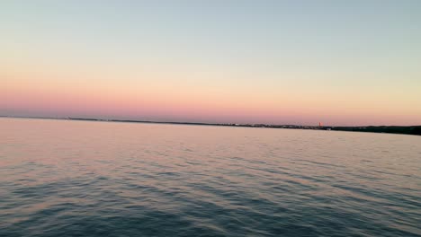 Schöner-Blick-Auf-Die-Ostseebucht-Bei-Sonnenuntergang,-Wolkenloser-Himmel-Am-Horizont,-Orangetöne-In-Der-Ferne-Und-Ein-Ruhiges-Meer