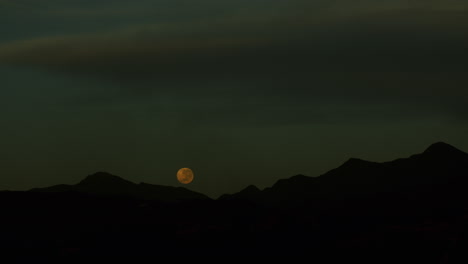 Footage-of-Super-moon-setting-over-the-hills-during-early-morning