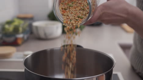 Woman-pouring-grains-into-a-bowl-for-cooking