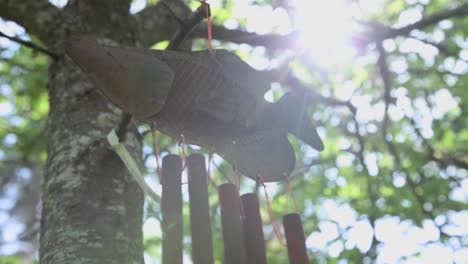Fish-Shaped-Rusty-Wind-chime-hanging-and-swaying-in-the-Garden