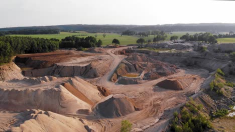 Aerial-dolly-shot-from-a-drone-of-quarry-and-heavy-machinery-in-pomeranian-district-in-Poland