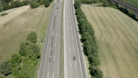 Drone-Aerial-view-of-the-German-Autobahn-in-bright-sunlight,-Germany,-Europe