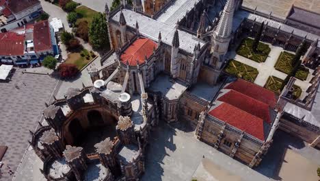 Aerial-tilting-shot-of-the-unfinished-chapel-and-the-batalha-monastery,-Portugal