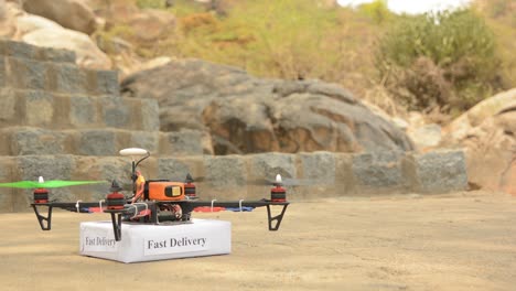 Concept-product-delivery-from-a-drone,-Custom-drone-or-quadcopter-taking-off-with-box-from-ground